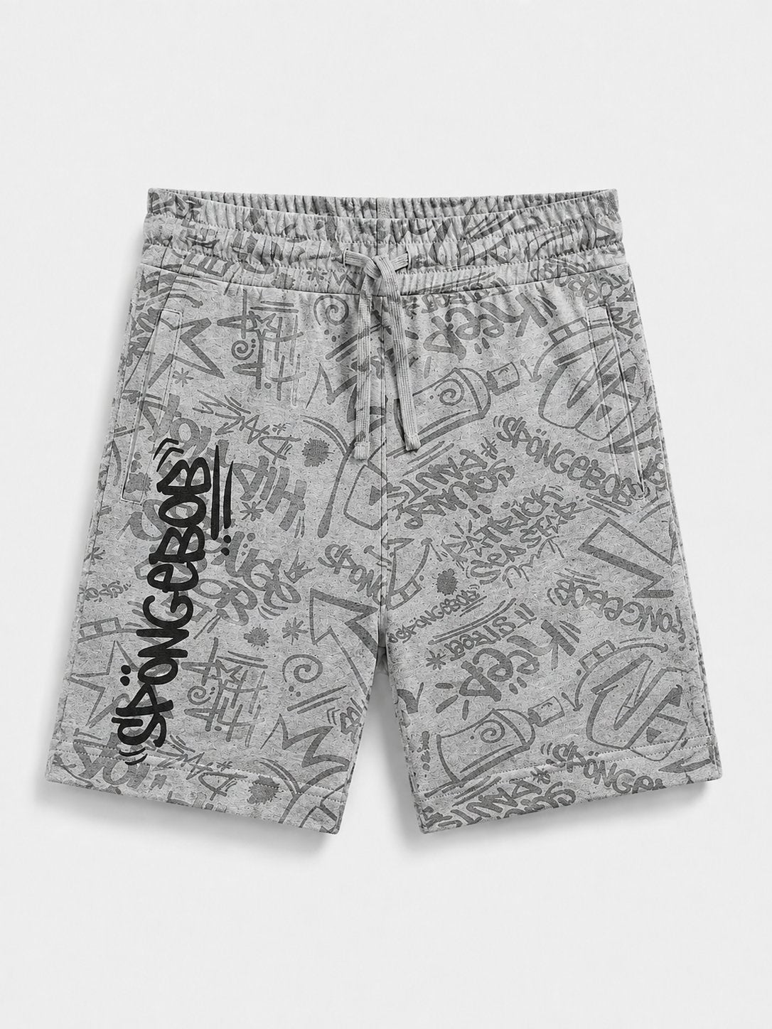 A pair of gray and white graffiti-print sweat shorts with a black SpongeBob logo printed vertically on the left leg, displayed flat against a light gray background.