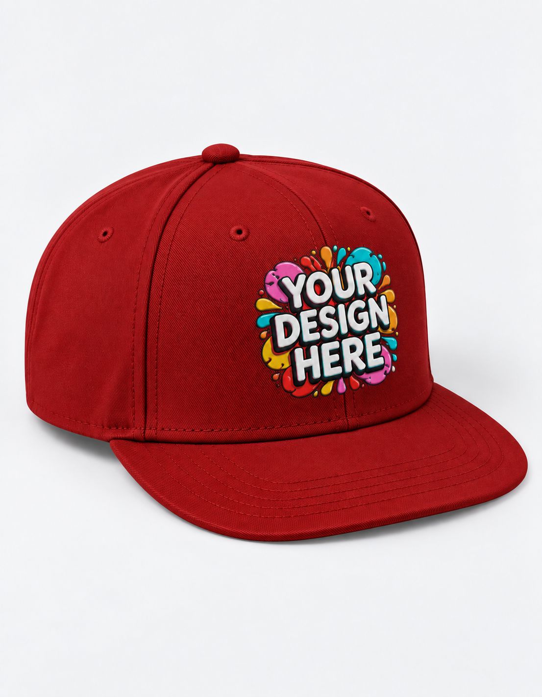 A red flat-brim Snapback cap with a colorful 'YOUR DESIGN HERE' graphic on the front, displayed on a clean white background.