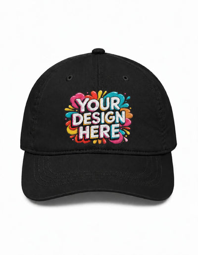 A black baseball cap with a colorful 'YOUR DESIGN HERE' mockup graphic on the front, set against a plain white background.