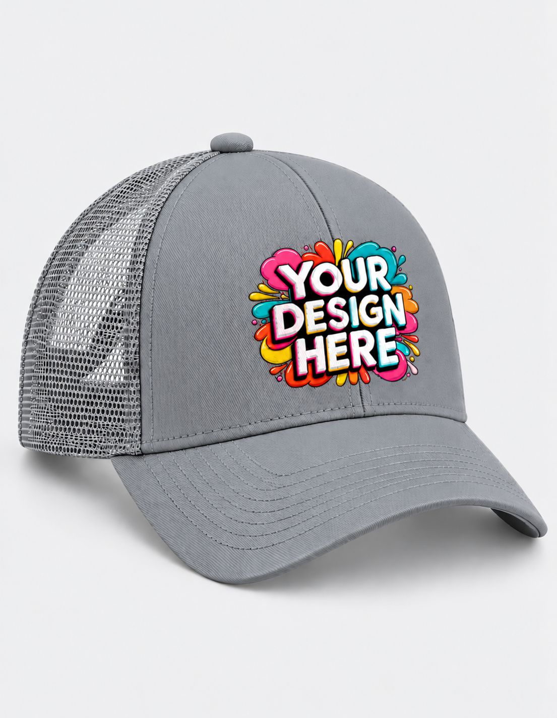 A gray trucker-style baseball cap with a curved brim and mesh back panels, featuring a colorful 'YOUR DESIGN HERE' graphic on the front. The cap is shown on a light gray background.