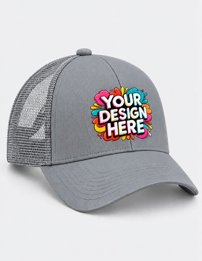 A gray trucker-style baseball cap with a curved brim and mesh back panels, featuring a colorful 'YOUR DESIGN HERE' graphic on the front. The cap is shown on a light gray background.