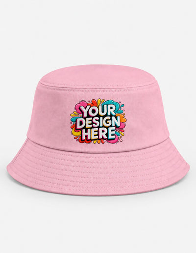 A light pink bucket hat with a colorful 'YOUR DESIGN HERE' graphic printed on the front, set against a plain white background.