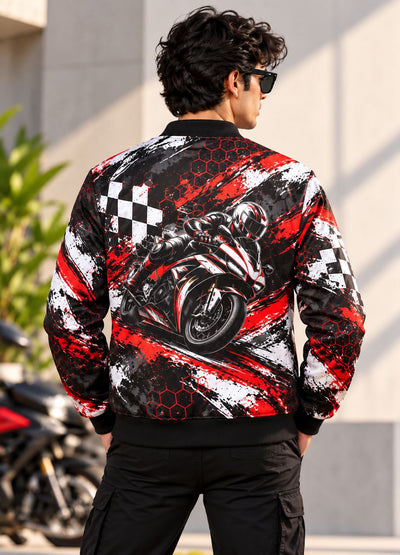 A man viewed from behind wearing a black bomber jacket with a large graphic print of a motorcycle racer on the back, featuring red and white brushstroke patterns and checkered flags.