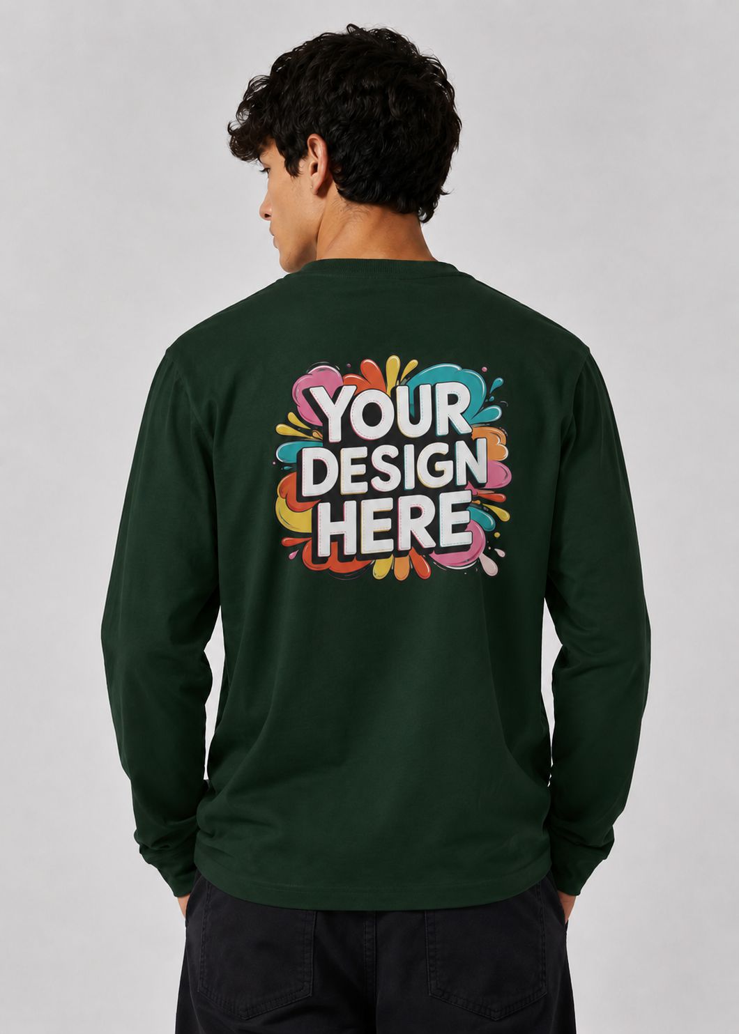A man viewed from the back wearing a dark green long-sleeve t-shirt with a colorful 'YOUR DESIGN HERE' mockup graphic printed on the back, set against a plain light gray background.