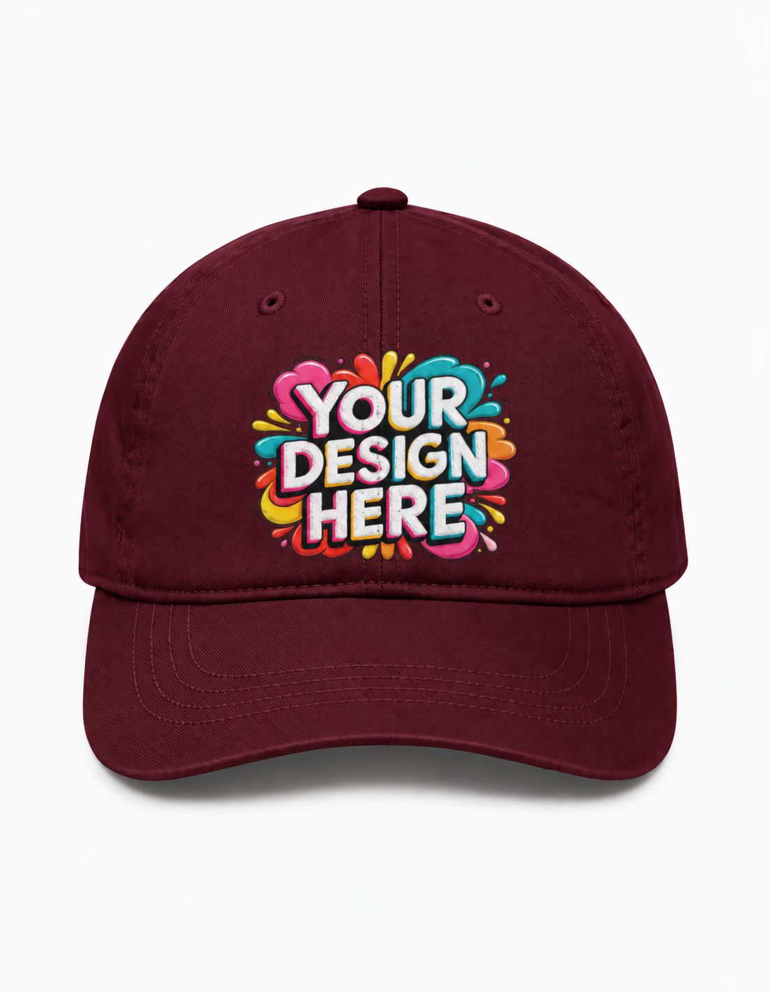 A maroon baseball cap with a colorful 'YOUR DESIGN HERE' graphic printed on the front, set against a plain white background.