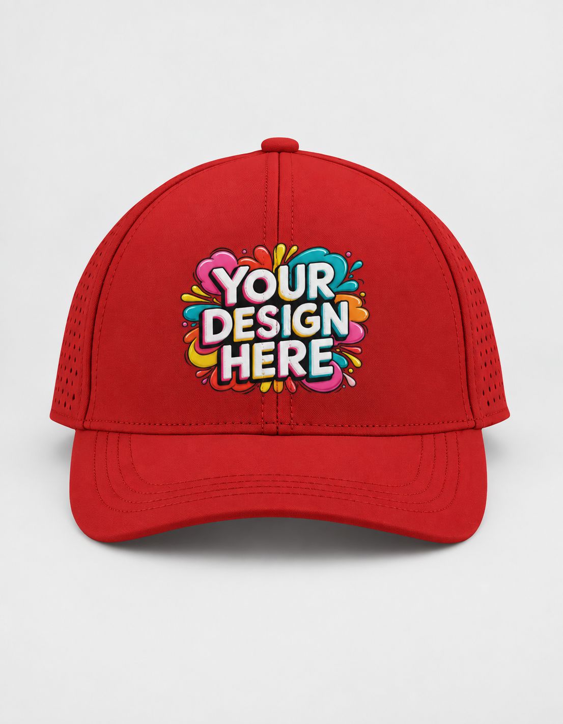 A red sports cap with a colorful 'YOUR DESIGN HERE' mockup graphic on the front, set against a plain light gray background.