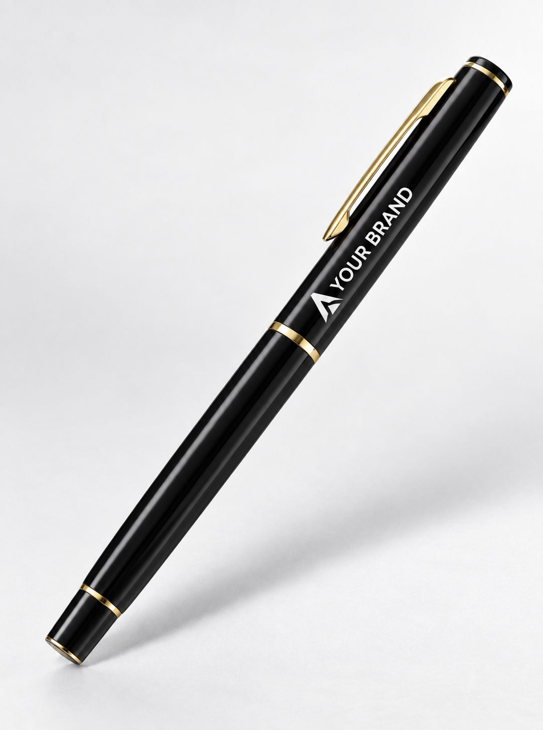 A sleek black pen with gold trim and a gold clip, featuring the customizable text 'YOUR BRAND' printed in white on the barrel, set against a clean light gray background.