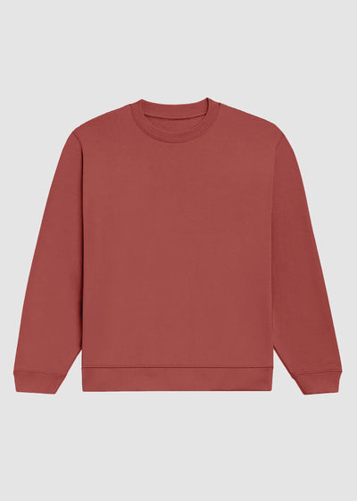 A solid dusty rose crewneck sweatshirt with long sleeves and ribbed cuffs and hem, displayed flat against a light gray background.