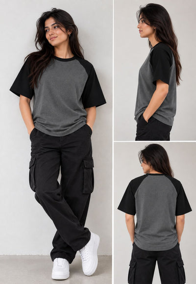 A woman modeling a short-sleeve raglan T-shirt in three views: front, side, and back. The shirt has a dark gray body with black sleeves and collar.