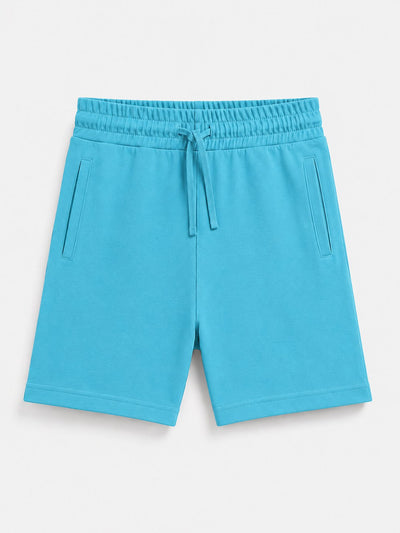 Bright turquoise blue sweat shorts with an elastic drawstring waist and side pockets, shown flat on a light gray background.
