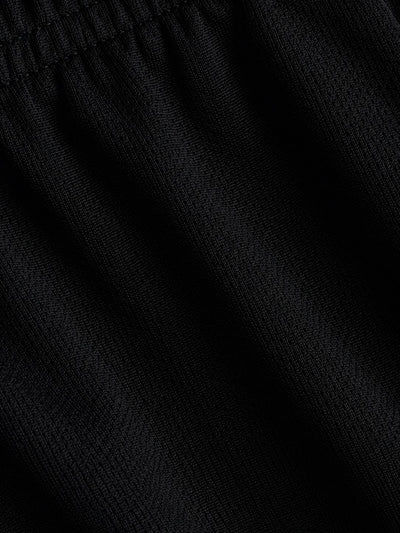Close-up of black textured knit fabric with a gathered elastic waistband.