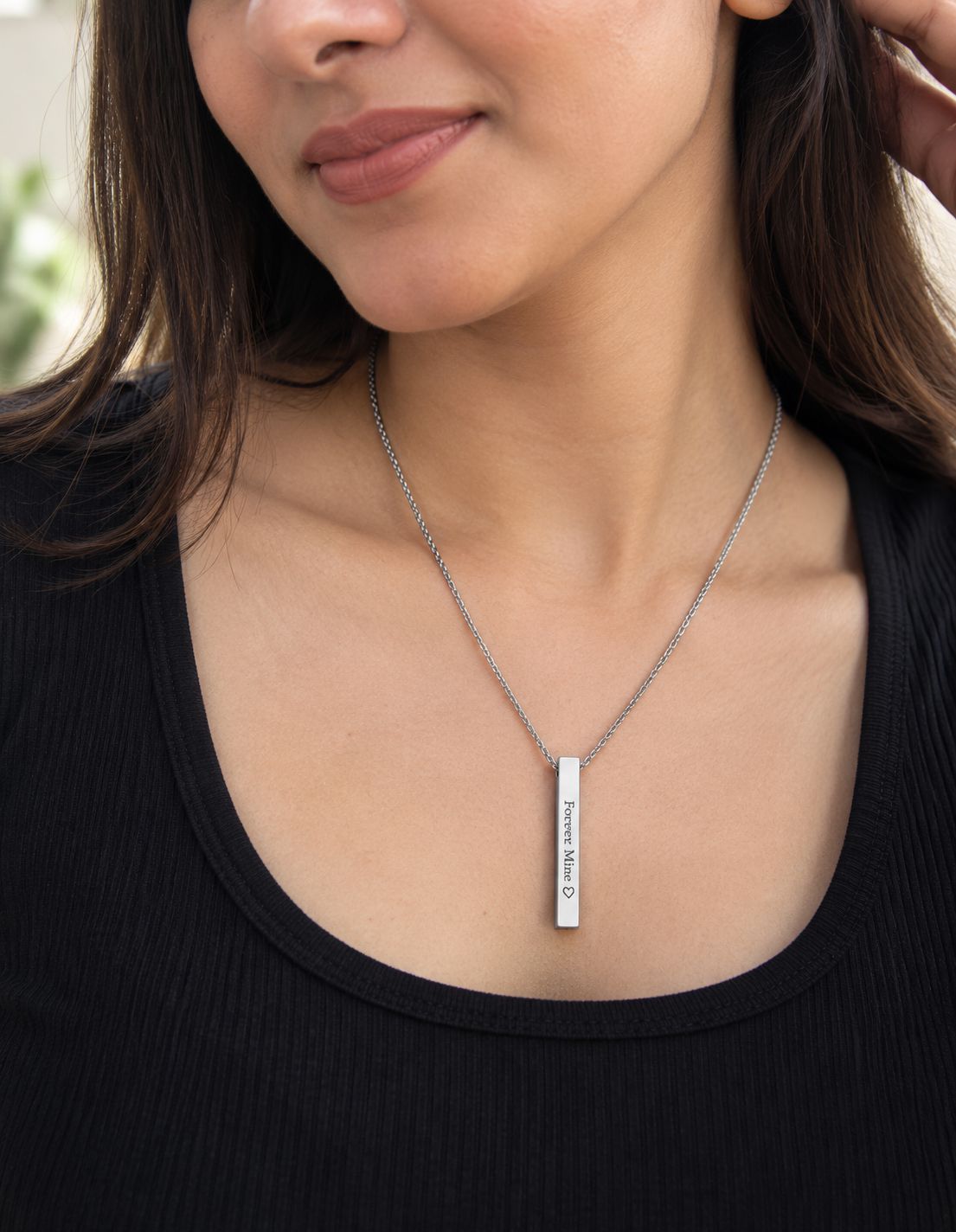 Custom engraved bar pendant necklace worn by woman