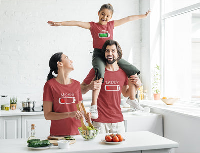 Family of three in matching red t-shirts with battery icons.