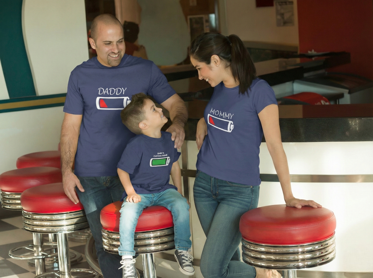 Family of three wearing matching 'Battery'  Blue Tshirts