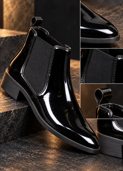 Close-up of a black patent Chelsea boot showing its elastic gusset and pull tab