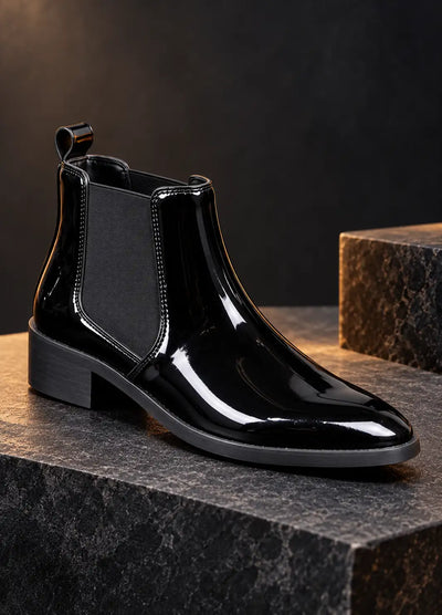 Single black patent Chelsea boot with elastic side panel and pull tab