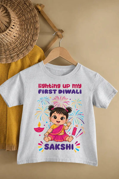 Gray baby T-shirt with a colorful Diwali fireworks and girl graphic, personalized with a name.