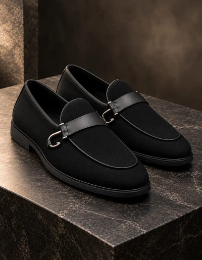 Pair of black loafers with suede-finish uppers and polished metal bit straps