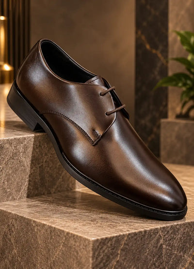 Brown faux leather lace-up dress shoe with pointed toe and black sole