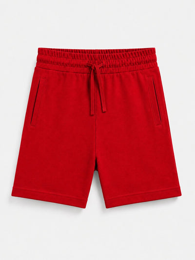 Red drawstring shorts with side pockets, photographed flat against a light gray background.