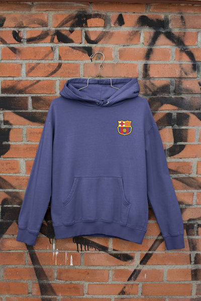 Royal blue hoodie with a logo on a hanger against a graffiti-covered brick wall