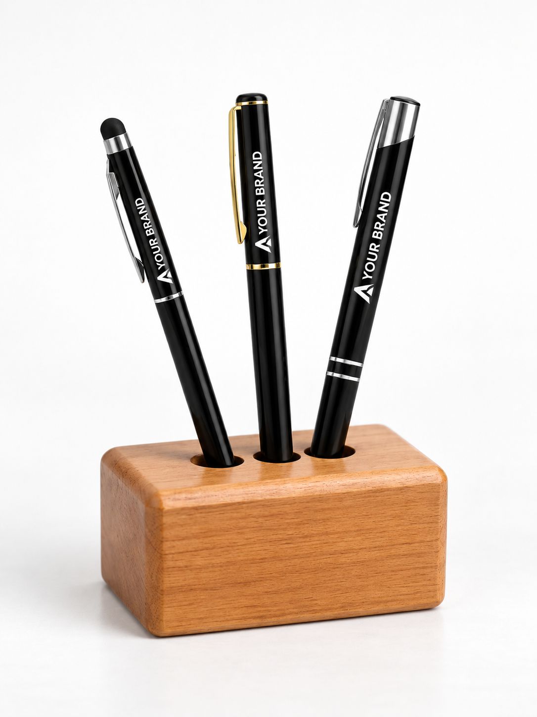 Three black customizable pens with silver and gold accents are displayed in a wooden pen stand on a white background.