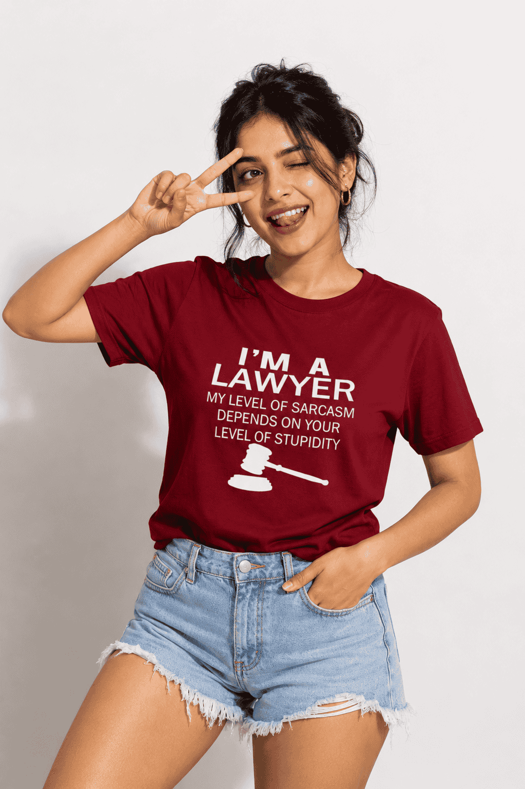 Woman wearing a red t-shirt with 'I'm a Lawyer' text and a gavel graphic, making a peace sign.