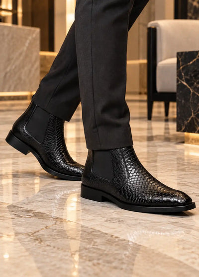 Black croc-texture Chelsea boots worn with dark trousers