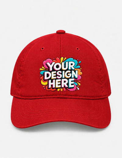 A red baseball cap with a colorful 'YOUR DESIGN HERE' mockup graphic on the front, set against a light gray background.